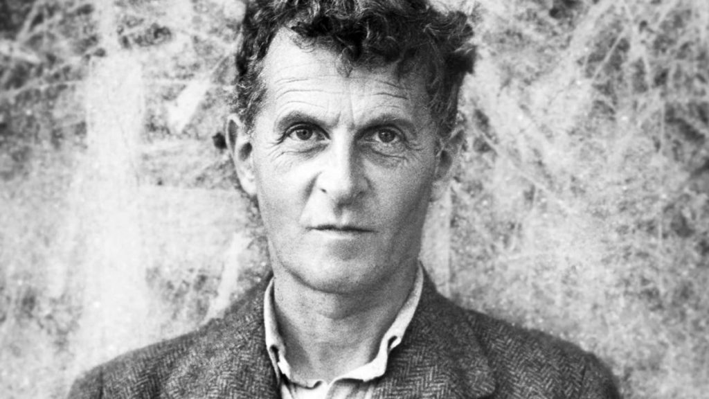 Retrato en blanco y negro de Ludwig Wittgenstein, filósofo austriaco, con expresión seria y cabello oscuro desordenado