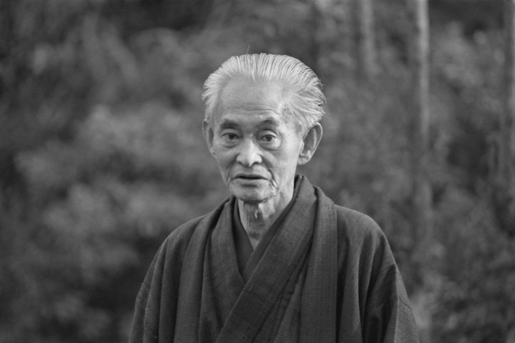Retrato en blanco y negro de Yasunari Kawabata, escritor japonés de cabello blanco, vistiendo kimono oscuro