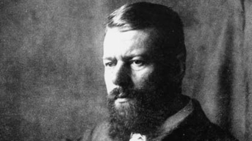 Retrato en blanco y negro de Max Weber, sociólogo alemán, con barba y traje oscuro