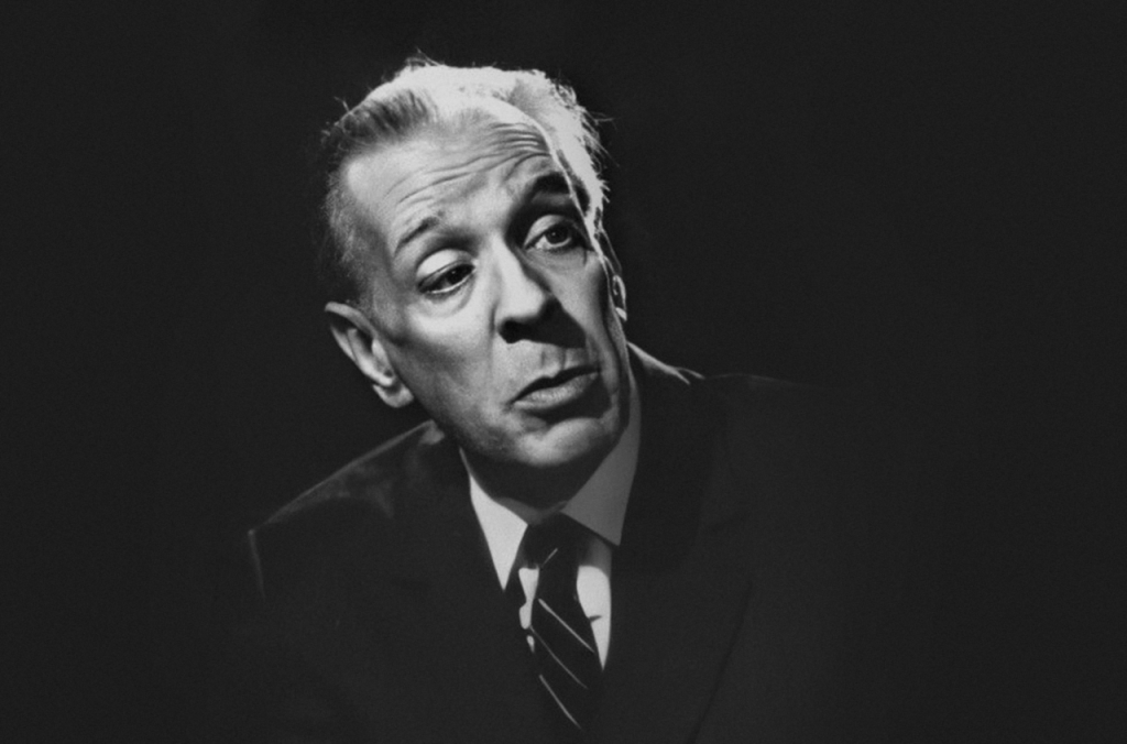 Jorge Luis Borges, escritor argentino, retrato en blanco y negro con expresión pensativa mirando hacia arriba