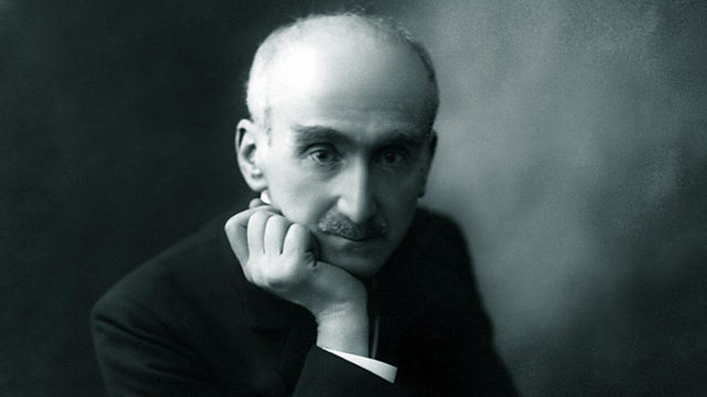 Henri Bergson, filósofo francés, en retrato de perfil con la mano en la mejilla, expresión reflexiva, fondo oscuro